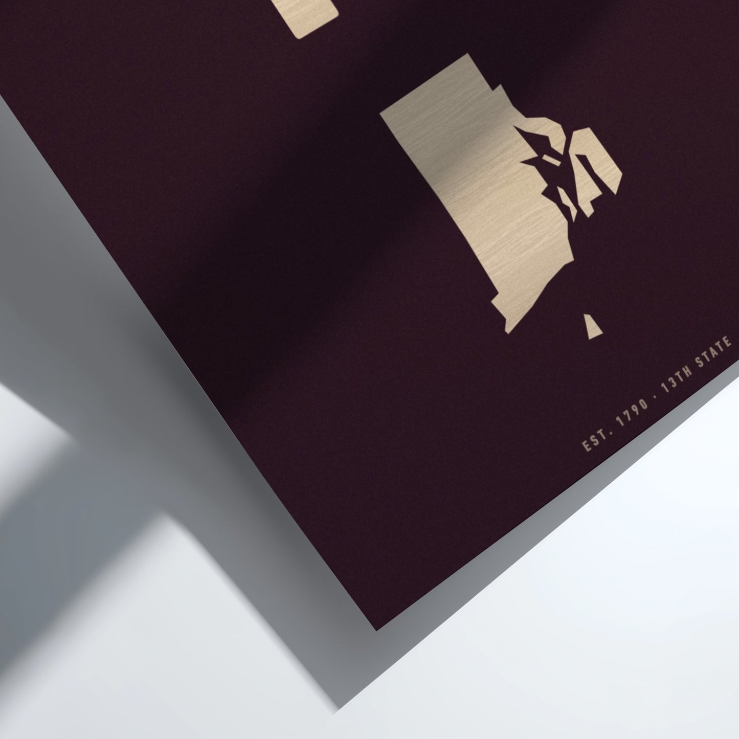 Maroon book with gold embossed design  of Rhode Island on a white background