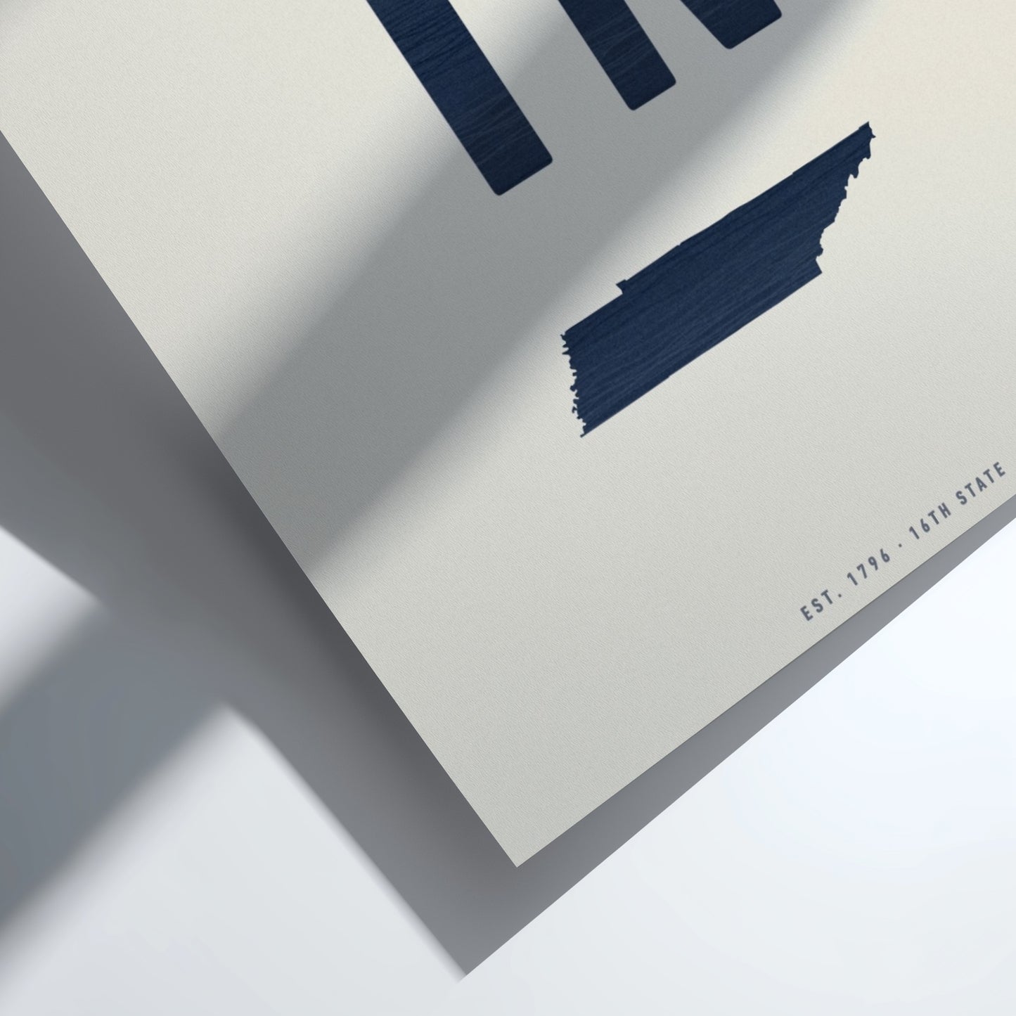 Close-up of a folded paper with blue geometric shapes on a white background