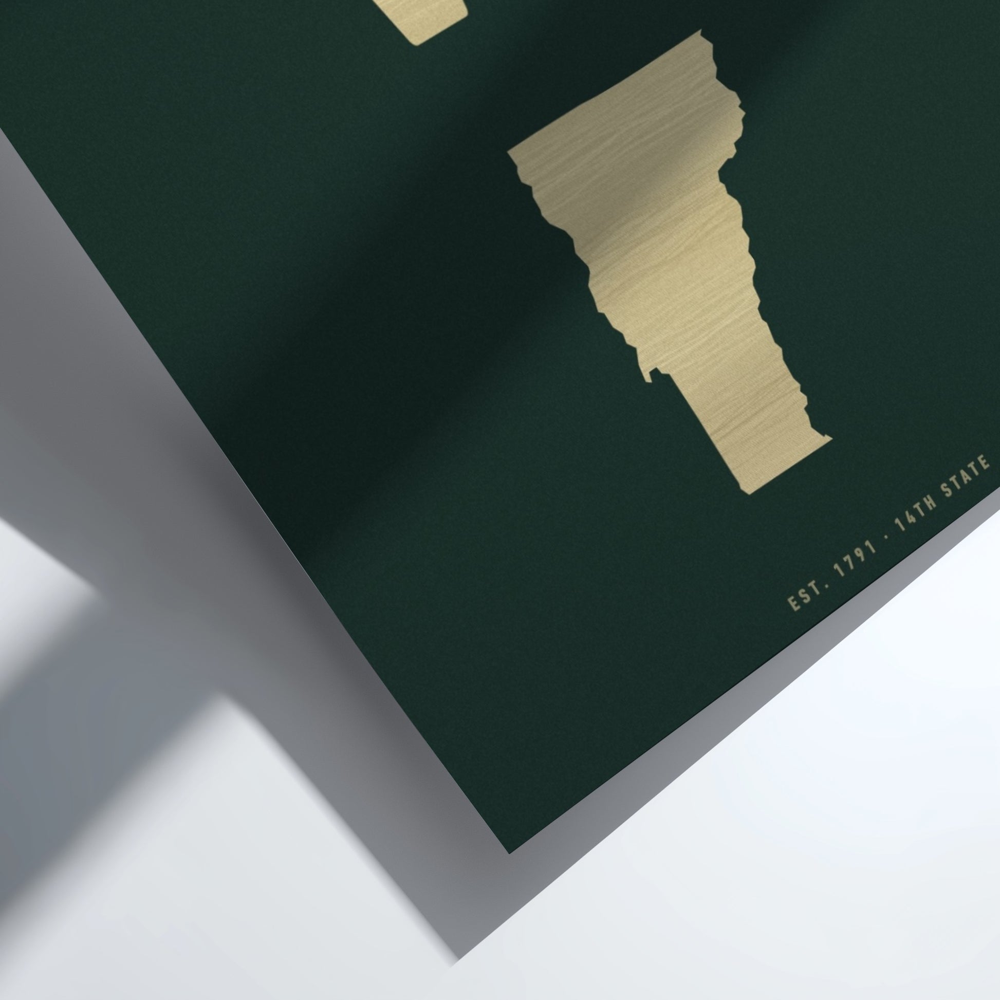 Map of Vermont with gold outline on a dark green background
