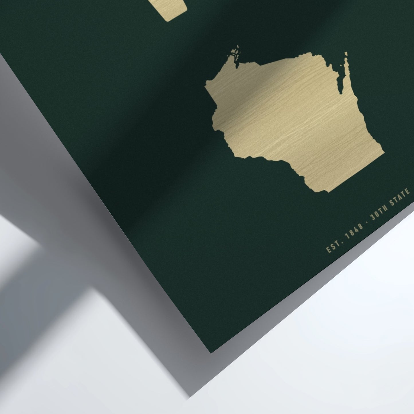 Gold map of Wisconsin on a dark green background