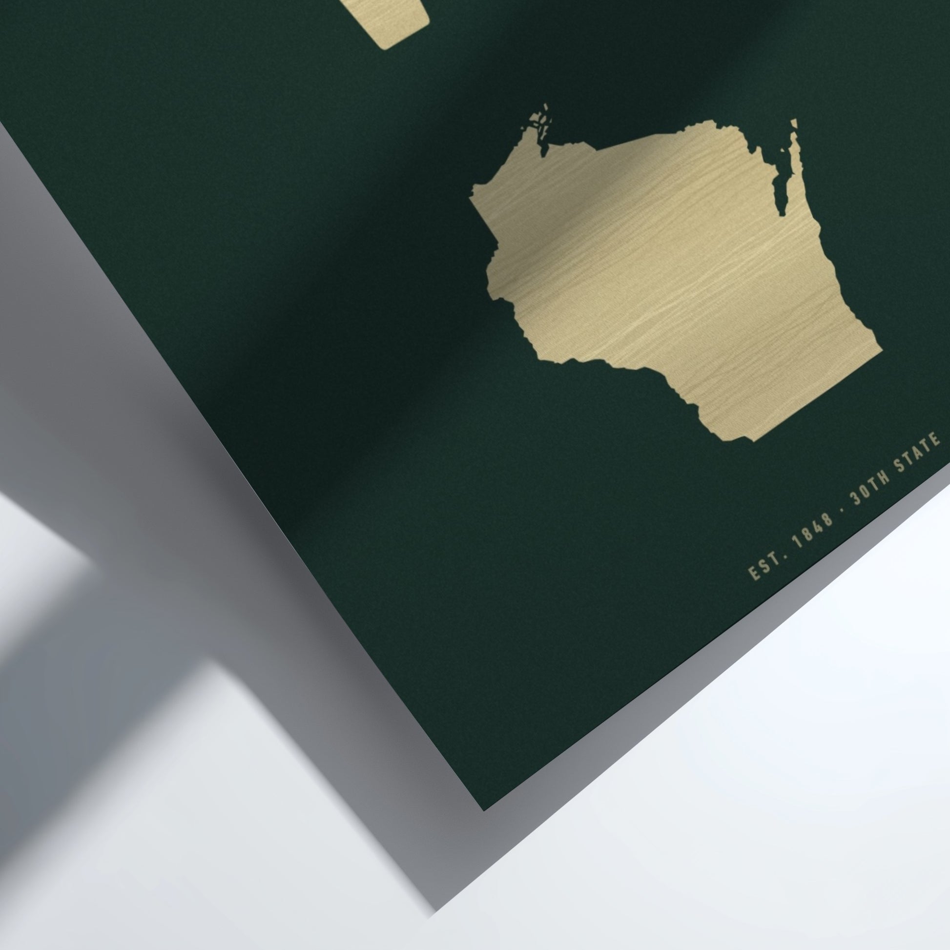 Gold map of Wisconsin on a dark green background