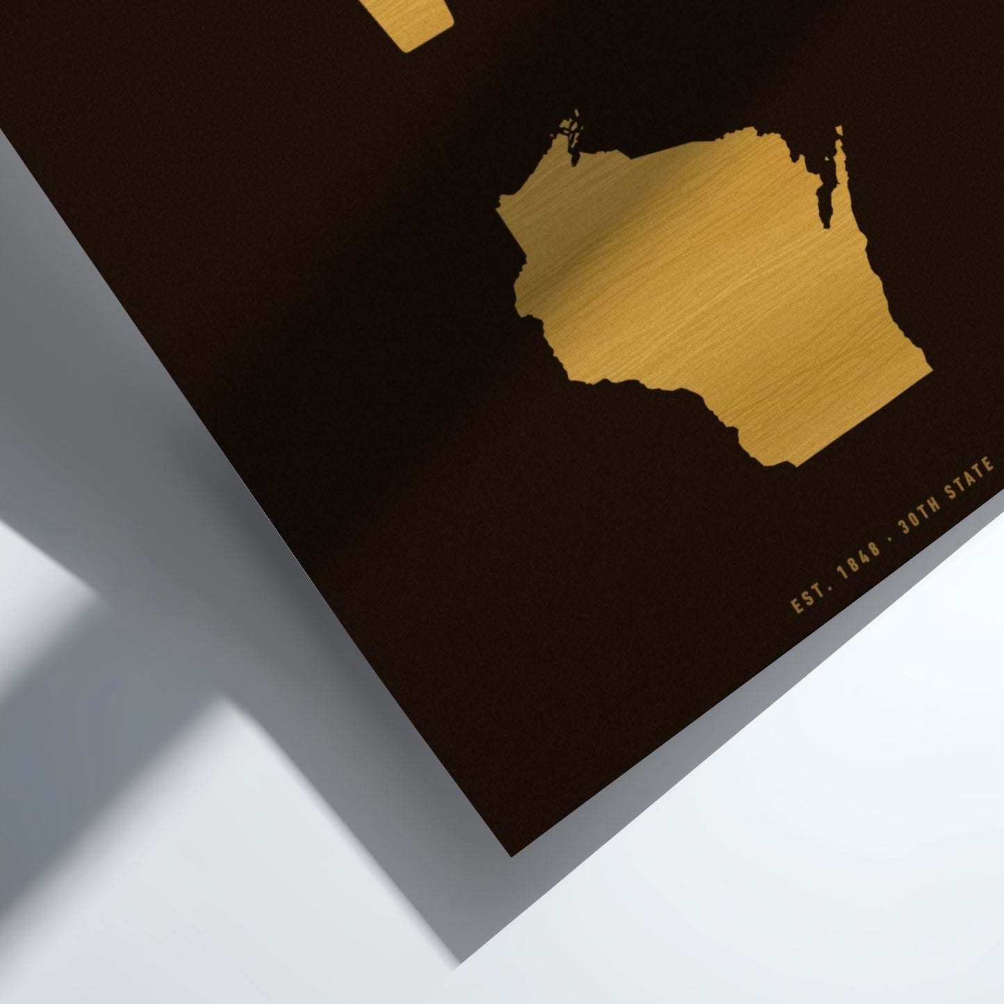 Gold map of Wisconsin on a black background
