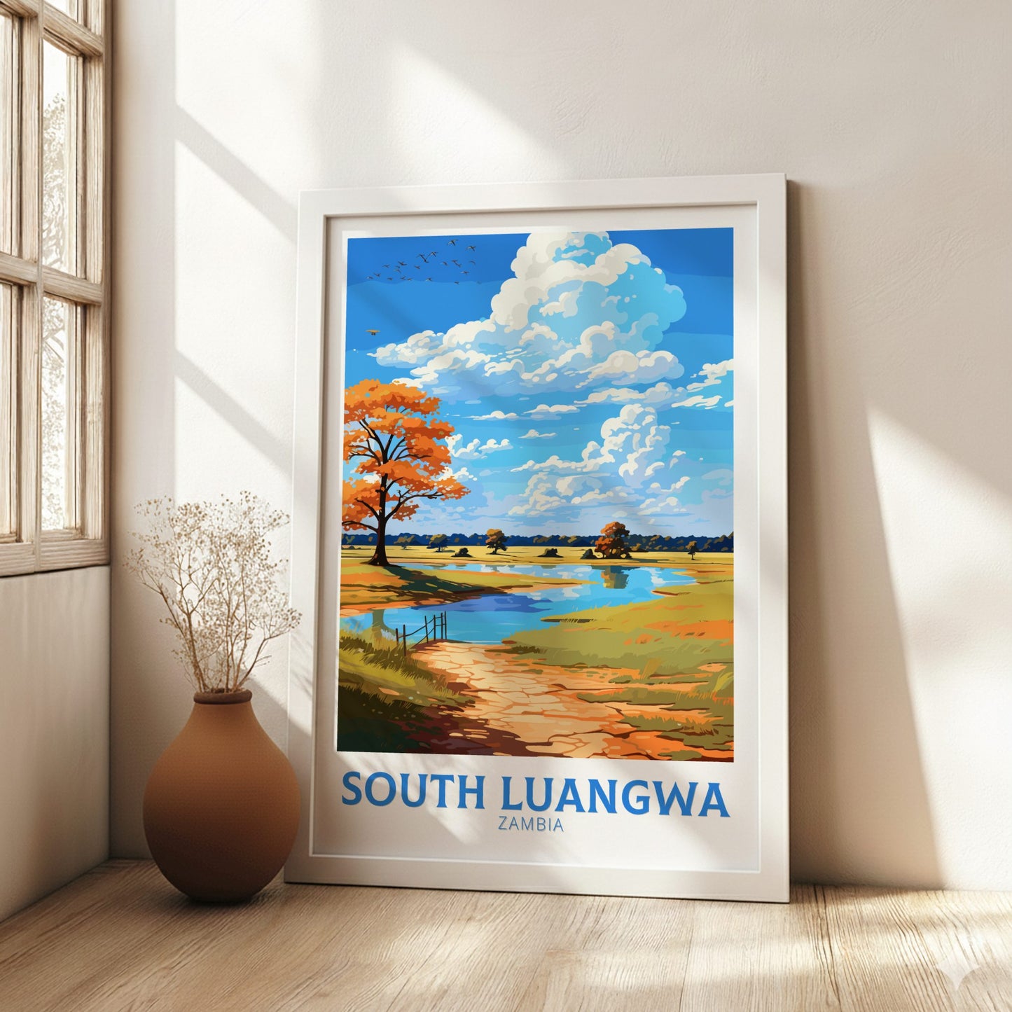 Framed artwork of South Luangwa, Zambia with a scenic landscape on a wall.