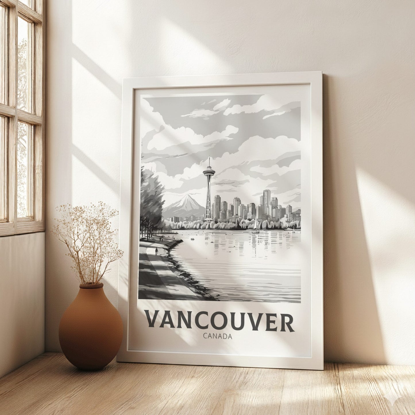 Framed artwork of Vancouver with a vase on a wooden floor.