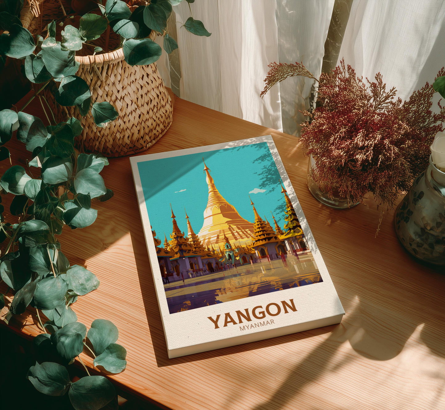Canvas with a cover featuring Yangon, Myanmar on a wooden table with plants.
